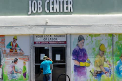 In this May 7, 2020 file photo, a person looks inside the closed doors of the Pasadena Community Job Center in Pasadena, CA during the coronavirus outbreak.
