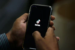 A man opens social media app 'TikTok' on his cell phone.
