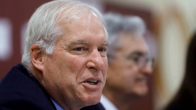 In this Nov. 25, 2019 file photo Federal Reserve Bank of Boston President Eric Rosengren, left, speaks during a round table discussion at Silver Lane Elementary School, in East Hartford, Conn. Rosengren said in remarks delivered online Wednesday, Aug. 12, 2020, that states in the South and West that allowed their businesses to reopen after short shutdowns saw an initial burst of economic activity. But spikes in infection rates soon followed and those states’ economies are now lagging those in the Northeast as consumers have become more cautious.