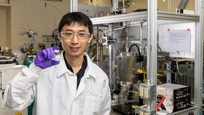 Zhenglong Li, an ORNL scientist in the Energy and Transportation Science Division, holds a sample of a catalyst material used to covert ethanol into butene-rich mixed olefins.