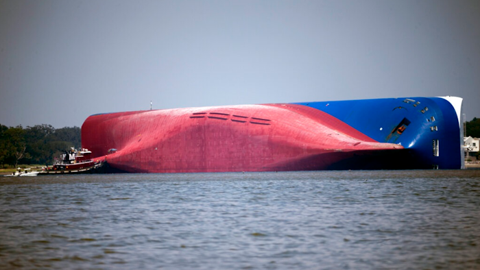 A Moran tugboat nears the stern of the capsizing vessel Golden Ray near St. Simons Sound off the coast of Georgia, Sept. 9, 2019.