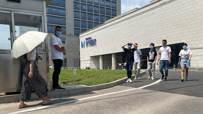 Employees exit the ByteDance headquarters in Beijing, Aug. 7, 2020.