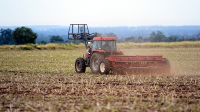 In this May 21, 2013 photo, a dairy farmer sows barley on his property on the Darling Downs in Brisbane, Australia.