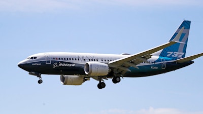 A Boeing 737 Max jet heads to a landing at Boeing Field following a test flight in Seattle.