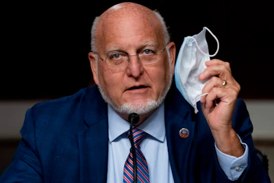 Centers for Disease Control and Prevention Director Dr. Robert Redfield holds up his mask as he speaks at a Senate Appropriations subcommittee hearing on a 'Review of Coronavirus Response Efforts' on Capitol Hill on Wednesday, Sept. 16, in Washington.