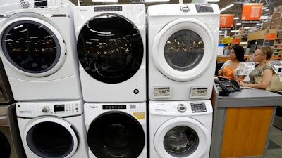 Clothes dryers are stacked on top of washing machines at a Home Depot in Boston.