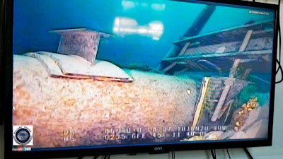 Shot from a television screen shows damage to anchor support EP-17-1 on the east leg of the Enbridge Line 5 pipeline within the Straits of Mackinac in Michigan.