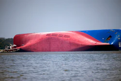 A Moran tugboat nears the stern of the capsizing vessel Golden Ray near St. Simons Sound off the coast of Georgia, Sept. 9, 2019.