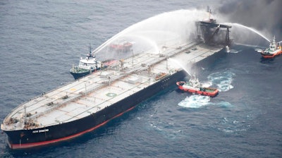 This photo released by Sri Lankan Air Force shows ships fighting fire on the MT New Diamond, about 30 nautical miles off the coast of Sri Lanka, Tuesday, Sept. 8, 2020. Ships and aircraft from Sri Lanka and India intensified efforts to extinguish a new fire on an oil tanker off Sri Lanka's coast on Tuesday, two days after the previous three-day blaze was doused, the navy said.
