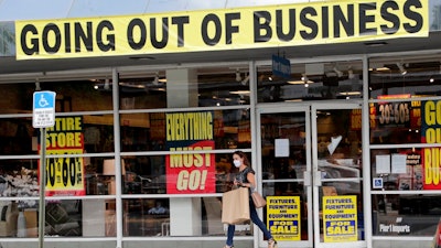 In this Aug. 6, 2020, file photo, a customer leaves a Pier 1 retail store, which is going out of business, during the coronavirus pandemic in Coral Gables, Fla. The Labor Department reported unemployment numbers Thursday, Sept. 3.