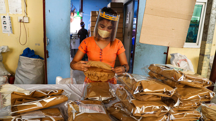 A woman wearing face mask and face shield.