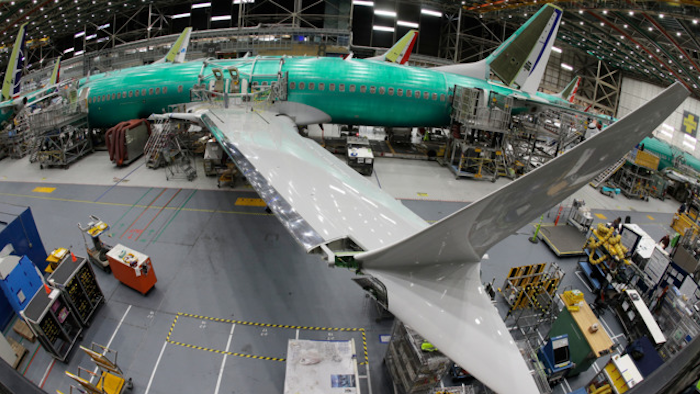 In this March 27, 2019, photo taken with a fish-eye lens, a Boeing 737 MAX 8 airplane sits on the assembly line during a brief media tour in Boeing's 737 assembly facility in Renton, Wash.
