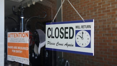 A closed sign in the window of a barber shop in Burbank, Calif., July 18, 2020.