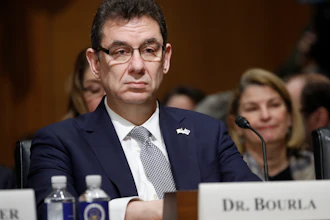 In this Tuesday, Feb. 26, 2019 file photo, Albert Bourla, chief executive officer of Pfizer, prepares to testify before the Senate Finance Committee hearing on drug prices, on Capitol Hill in Washington. On Thursday, Oct. 1, 2020, Bourla wrote to Pfizer employees that he's “disappointed” the timing for a vaccine to be available was politicized during Tuesday night’s presidential debate, saying the company won’t succumb to political pressure.