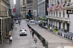 A police car patrols in front of the New York Stock Exchange on Wednesday, Oct. 7.