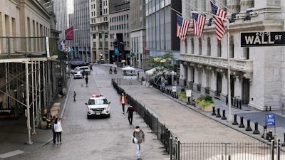 A police car patrols in front of the New York Stock Exchange on Wednesday, Oct. 7.