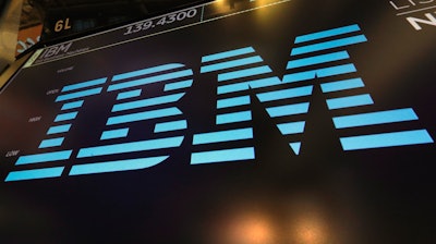 In this March 18, 2019, file photo, the logo for IBM appears above a trading post on the floor of the New York Stock Exchange. IBM says it is breaking off a $19 billion chunk of its business to focus on cloud computing. The 109-year-old tech company said Thursday, Oct. 8, 2020, it is spinning off its managed infrastructure services unit into a new public company, temporarily named NewCo.