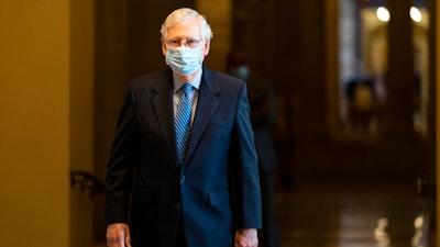 Senate Majority Leader Mitch McConnell, R-Ky., walks towards the Senate floor, Oct. 1, 2020.