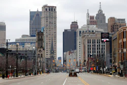 In this March 24, 2020 file photo, Woodward Avenue is shown nearly empty in Detroit. Before the coronavirus showed up, downtown Detroit was returning to its roots as a vibrant city center, motoring away from its past as the model of urban ruin. Now, with the coronavirus forcing many office workers to their homes in the suburbs, those who remain wonder if revitalization will ever return.