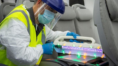 A Boeing employee uses the UV wand on an area with MS2.