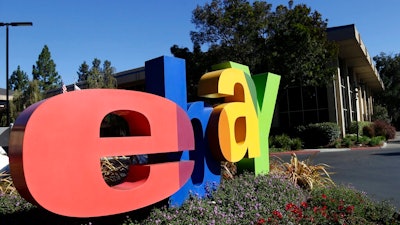 In this Oct. 17, 2012, file photo, an eBay sign sits in front of the company's headquarters in San Jose, Calif. On Wednesday, Sept. 23, 2020, federal prosecutors said four former eBay Inc. employees had agreed to plead guilty to their roles in a campaign of intimidation that included sending live spiders and cockroaches to the home of a Massachusetts couple who ran an online newsletter highly critical of the auction site.