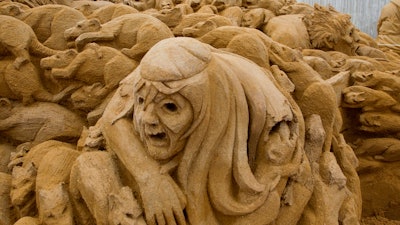 Sand sculpture of a covert with rats and the black death. This sand sculpture was made and photographed by Bouke Atema.