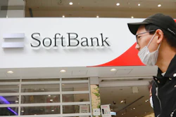 People walk by a SoftBank shop in Tokyo, Monday, Nov. 9, 2020.