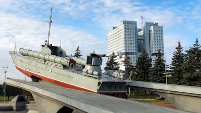 The building and the torpedo boat, the Baltic Sailors Memorial, in Kaliningrad, Russia, Thursday, Oct. 29, 2020. The hulking never-occupied building sardonically likened to a robot's head that has loomed over the city of Kaliningrad for decades is to be demolished next year, the region's governor says. The 21-story House of Soviets was left unfinished when funding ran out in 1985 amid the Soviet Union's economic struggles and later was assessed to be structurally unsound.