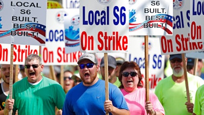 Striking Bath Iron Works shipbuilders march in solidarity.