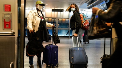 Travelers leave the AirTrain at JKF International Airport on Nov. 20 in New York.