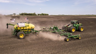 In this photo provided by Farm Rescue, volunteers plant crops on Paul Ivesdal's farm June 3, 2020 in Edmore, N.D.