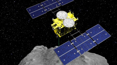 This computer graphics image released by the Japan Aerospace Exploration Agency (JAXA) shows the Hayabusa2 spacecraft above the asteroid Ryugu. The Japanese spacecraft is nearing Earth after a yearlong journey home from a distant asteroid carrying soil samples and data that could provide clues to the origins of the solar system, a space agency official said Friday, Nov. 27, 2020.
