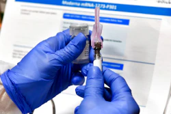 In this July 27, 2020, file photo, nurse Kathe Olmstead prepares a shot that is part of a possible COVID-19 vaccine, developed by the National Institutes of Health and Moderna Inc., in Binghamton, N.Y. Moderna said Monday, Nov. 16, 2020, its COVID-19 shot provides strong protection against the coronavirus that's surging in the U.S. and around the world.
