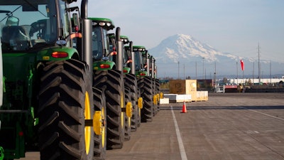In this Nov. 4, 2019 file photo, John Deere tractors made by Deere & Company are shown as they are readied for export to Asia at the Port of Tacoma in Tacoma, Wash. The U.S. trade deficit fell in September 2020 after hitting a 14-year high in August as exports outpaced imports. The Commerce Department reported, Wednesday, Nov. 4, 2020, the gap between what the U.S. sells and what it buys abroad fell to 63.9 billion in September, a decline of 4.7% from a $67 billion deficit in August.