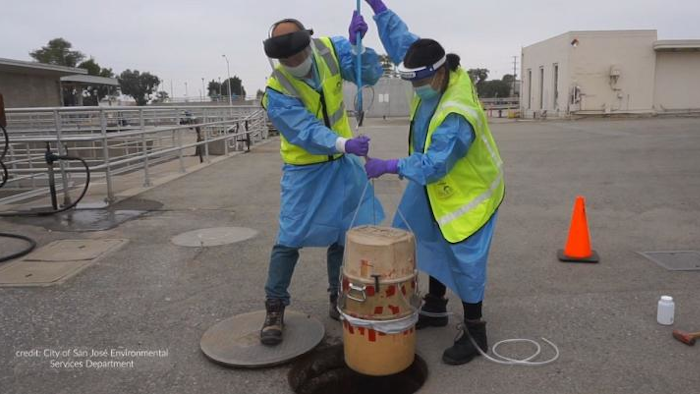 City of San José Environmental Services Department's environmental inspectors Isaac Tam and Laila Mufty deploy an autosampler into a manhole at the San José - Santa Clara Regional Wastewater Facility.