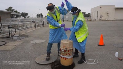 City of San José Environmental Services Department's environmental inspectors Isaac Tam and Laila Mufty deploy an autosampler into a manhole at the San José - Santa Clara Regional Wastewater Facility.