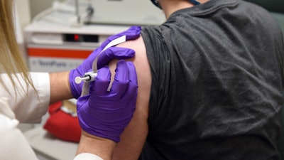 This May 4, 2020, file photo provided by the University of Maryland School of Medicine, shows the first patient enrolled in Pfizer's COVID-19 coronavirus vaccine clinical trial at the University of Maryland School of Medicine in Baltimore.