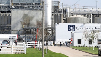 Tyson's Fresh Meat workers file in for a tour of safety measures put into place after the plant in Waterloo, Iowa, had to shut down due to a COVID-19 outbreak, May 2020.