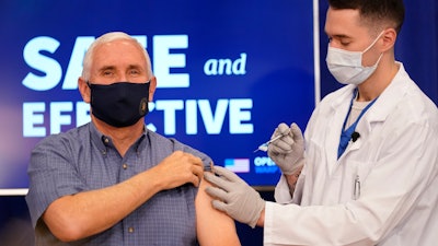 Vice President Mike Pence receives a Pfizer-BioNTech COVID-19 vaccine shot at the Eisenhower Executive Office Building on the White House complex, Friday, Dec. 18, 2020, in Washington. Karen Pence, and U.S. Surgeon General Jerome Adams also participated.