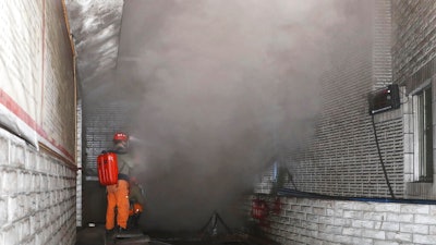 In this photo released by Xinhua News Agency, rescue workers gauge the density of carbon monoxide in the smog at the entrance of the coal mine in Yongchuan District of Chongqing, southwestern China, Friday, Dec. 4, 2020. China's state TV says more than a dozen coal miners have been killed by high levels of carbon monoxide in the country's southwest.