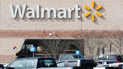 This March 17, 2020 photo shows a Walmart store in Mebane, N.C. Walmart says for the fourth time during the pandemic it will give its 1.5 million U.S. part-time and full-time employees additional cash bonuses for their work. The move, announced Thursday, Dec. 3, follows similar announcements in recent weeks by such retailers as Target, Lowe’s, and Amazon which are offering another round of bonuses as virus cases surge around the country.