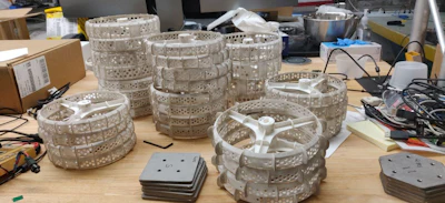 Sets of rover wheels are stacked and ready for mobility testing.