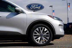 In this Oct. 11, 2020 file photo, a row of 2020 Ford Escape sports-utility vehicles sits at a Ford dealership in Denver.