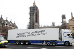A shellfish export truck with a protest sign written across the trailer 'Incompetent Government Destroying Shellfish Industry' drives past the Palace of Westminster in London on Monday, Jan. 18 during a demonstration by British Shellfish exporters to protest Brexit-related red tape they claim is suffocating their business.