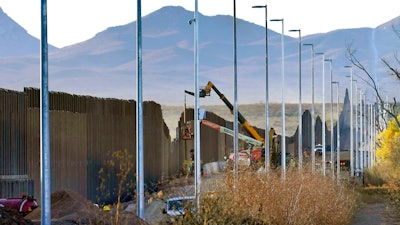 Crews construct a section of border wall in San Bernardino National Wildlife Refuge. The order leaves projects across the border unfinished and under contract.
