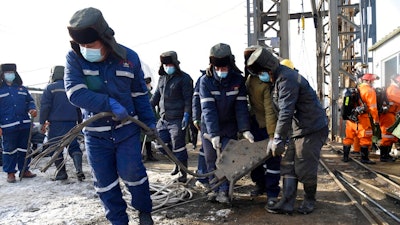 In this photo released by China's Xinhua News Agency, rescuers work at the site of a gold mine that suffered an explosion in Qixia in eastern China's Shandong Province, Tuesday, Jan. 12, 2021. Authorities have detained managers at a gold mine in eastern China where more than 20 workers have been trapped underground following an explosion Sunday.