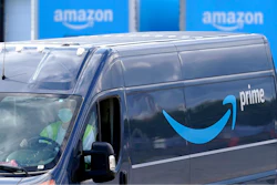 In this file photo, an Amazon Prime logo appears on the side of a delivery van as it departs an Amazon Warehouse. Online shopping has been a lifeline for many as the virus pandemic shuttered stores and kept people at home.