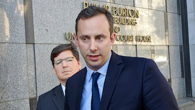 This Sept. 24, 2019 photo shows former Google engineer Anthony Levandowski, right, in front of his attorney, Miles Ehrlich, outside of a federal courthouse in San Francisco. President Donald Trump has pardoned Levandowski, who plead guilty to stealing trade secrets before joining Uber’s effort to build robotic vehicles for its ride-hailing service. Levandowski was among the more than 140 people included in a flurry of clemency action in the final hours of Trump’s White House term.