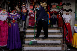 Victor Flores, 66, a third-generation owner of a gift shop, sweeps the steps of his store on Olvera Street in downtown Los Angeles. Millions of business owners are about to get additional help as they weather the coronavirus outbreak.