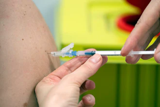 A member of staff at the university hospital injects the Moderna vaccine against COVID-19 into a patient in Duesseldorf, Monday, Jan. 18, 2021.